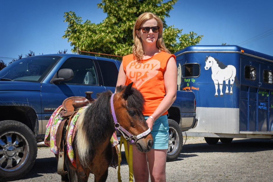 Danielle Burgess posed with Stella, one of the many ponies of Laughing Stock Ranch. Pony rides were just one of the many attractions of Saturday’s Celebrating Mount Pleasant festival.