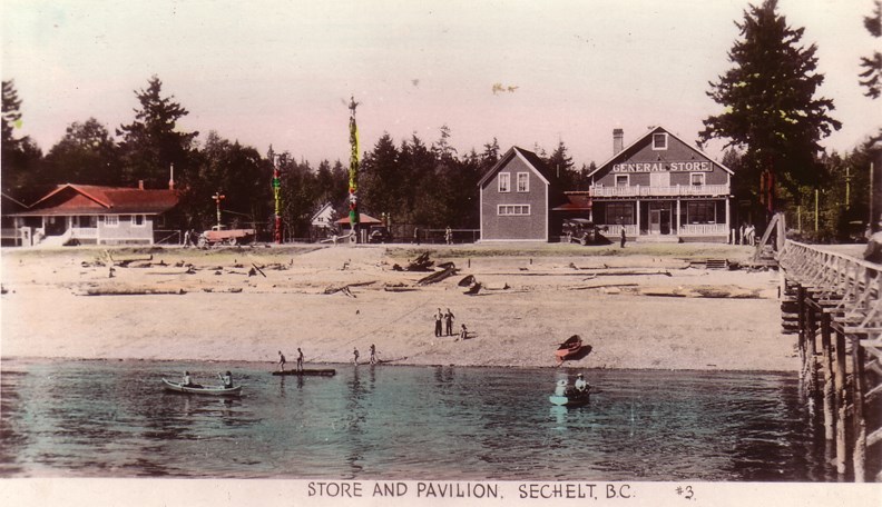 The tea room/dance pavilion, totem poles, and general store on the Sechelt waterfront in the 1930s. The general store was torn down in 1965-66. The tea room was built by Bert Whitaker in the early 1920s; the three totems were erected in 1928. These buildings were located at the site of the present-day Royal Terraces and Beach House condominiums.