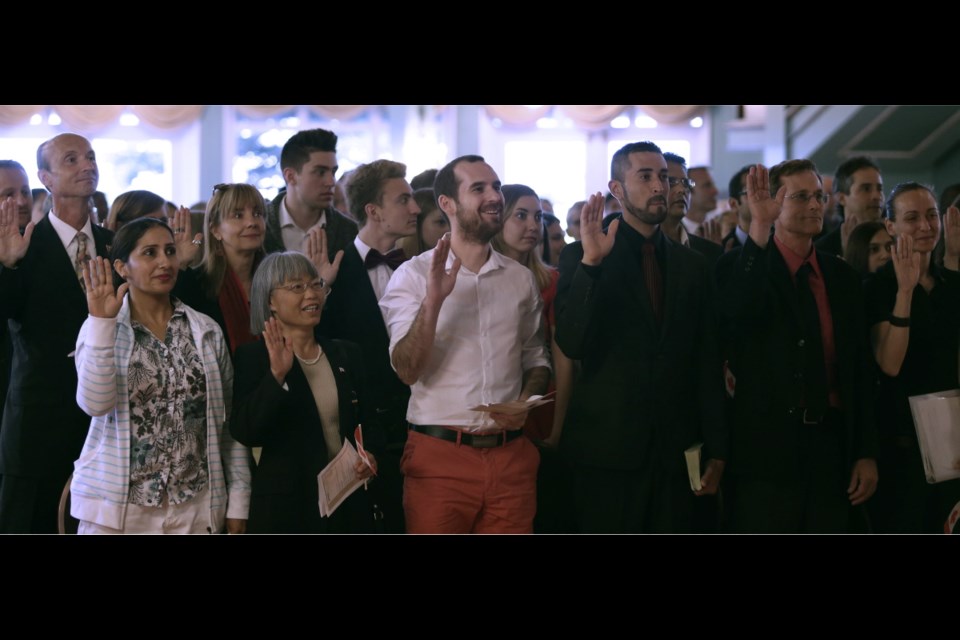 People take part in a Canada Day citizenship ceremony before the