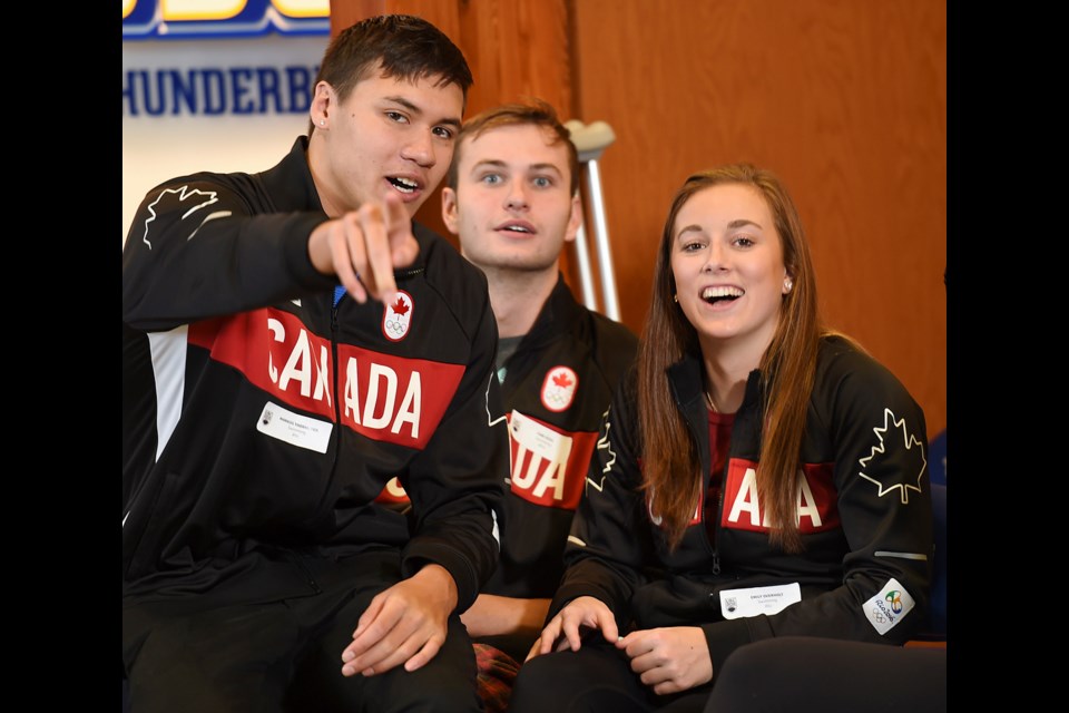 Olympic swimmers, from left, Markus Thormeyer, Yuri Kisil and Emily Overholt share a laugh before Wednesday’s Olympic send-off ceremony at UBC’s Doug Mitchell Thunderbird Sports Centre.