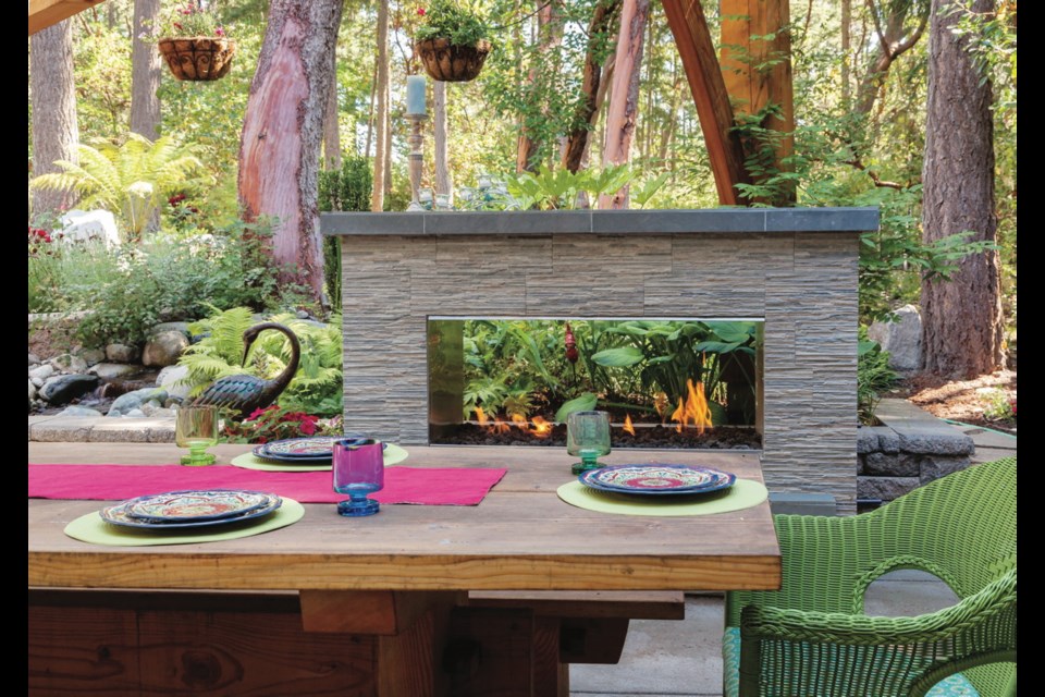 A spacious patio at the back of the house includes a see-through gas fireplace that draws the eye into the forest beyond.