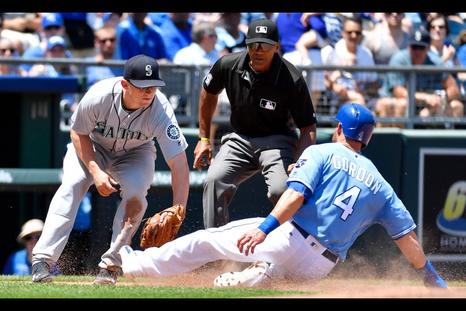 Kansas City Royals' Alex Gordon is tagged out by Seattle Mariners third baseman Kyle Seager on a fielder's choice hit by Drew Butera during the third inning on Sunday at Kauffman Stadium in Kansas City, Mo.