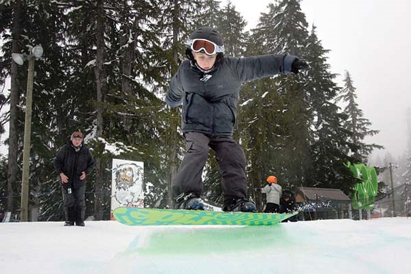 Cypress Mountain- Eight year-old Connor Leach practices his 180 on his snowboard in the mini terrain park.