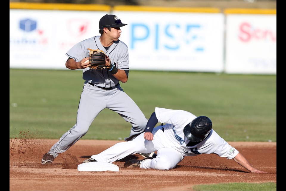 Victoria HarbourCats' Austin Guibor slides in late and is out at second base as Walla Walla Sweets' Jarren Duran looks to throw to first base.