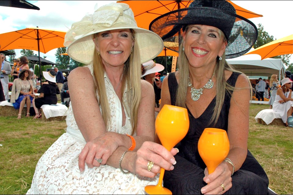 Sporting wide-brimmed hats, Macdonald Realty’s Lori Rowe and Trump International Hotel and Tower’s Teri Dill enjoyed a day of polo and people watching.