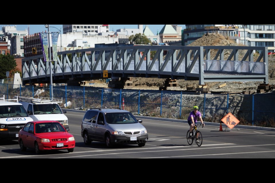 A 34-metre-long bridge for pedestrians and cyclists looks as though it's hanging in the air before being installed this weekend over Esquimalt Road with the aid of a large crane. The bridge links the E&N and Galloping Goose trails and serves as an approach to the new Johnson Street span, projected to open by early 2018.