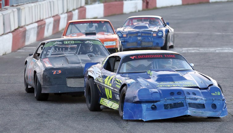 Chris Arronge (16) leads Wayne French (73) around the track during a Canadian Tire Street Stocks dash at PGARA Speedway on Saturday. Arronge trailed French by 20 points in the overall Canadian Tire Street Stocks standings going into the final night of racing for the season, with a championship trophy up for grabs in each class. Citizen Photo by James Doyle September 10, 2016