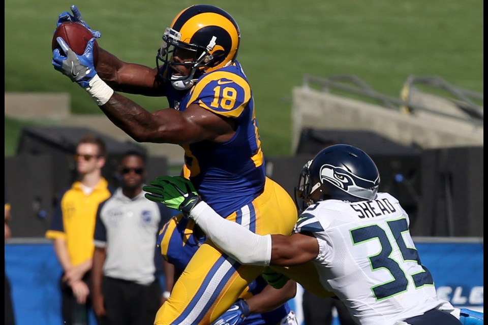 Los Angeles Rams wide receiver Kenny Britt makes a catch against Seattle Seahawks defensive back DeShawn Shead in the fourth quarter on Sunday at the Los Angeles Memorial Coliseum in Los Angeles, Calif.