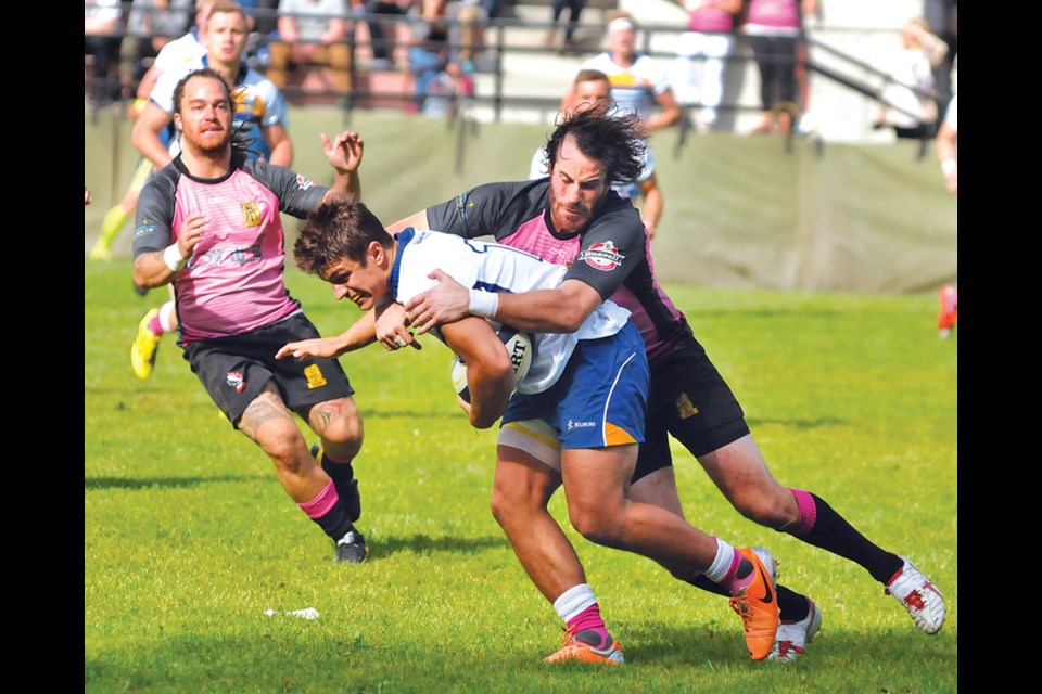 Greg Brown of the Capilano Rugby Club’s premier men’s team takes down a UBC ball carrier during Capilano’s home opener Saturday at Klahanie Park. The Thunderbirds, two-time defending Premier League champs, claimed a 28-8 win over Capilano. photo by Paul McGrath, North Shore News