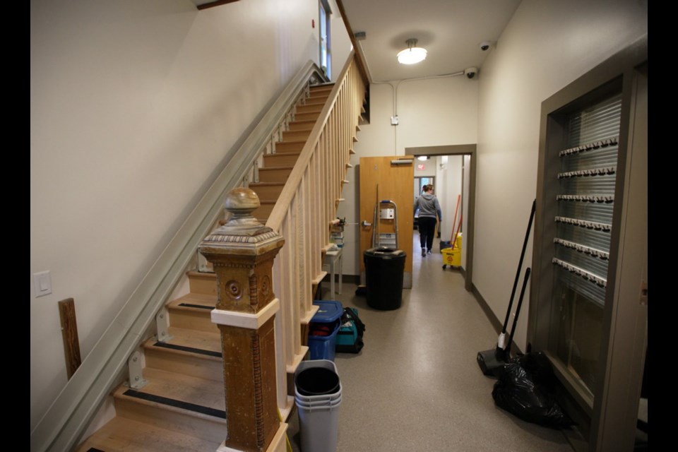 Volunteers put the finishing touches on the renovation of the Cool Aid Society's Sandy Merriman House on Friday. The downtown women's shelter reopens this weekend.