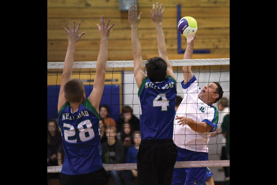 Old Buzzards Shayne Sabatino tips the ball past Kelly Road blockers. Citizen photo by Brent Braaten Nov 4 2016