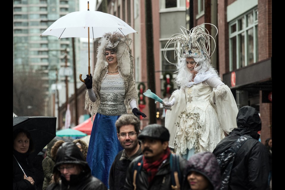 Ice queens on stilts entertained the crowds that filled Mainland Street for Yaletown’s CandyTown festival Saturday. The holiday street party was well-attended despite the torrential downpour. Photograph by: Rebecca Blissett