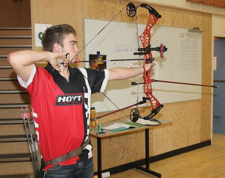 Spencer Schouwenburg, a member of the Silvertip Archery Club, shows off the technique he used when he recently shot a perfect round of 300 points at the Spruce Capital archery meet on Nov. 20.