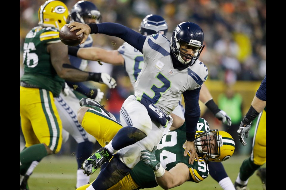 Green Bay Packers' Dean Lowry sacks Seattle Seahawks quarterback Russell Wilson during the first half of Sunday's game in Green Bay, Wis.