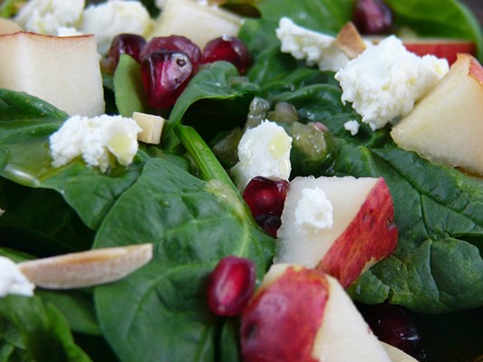 The pear pomegranate salad includes pomegranate seeds and snowy-white tufts of goat cheese.