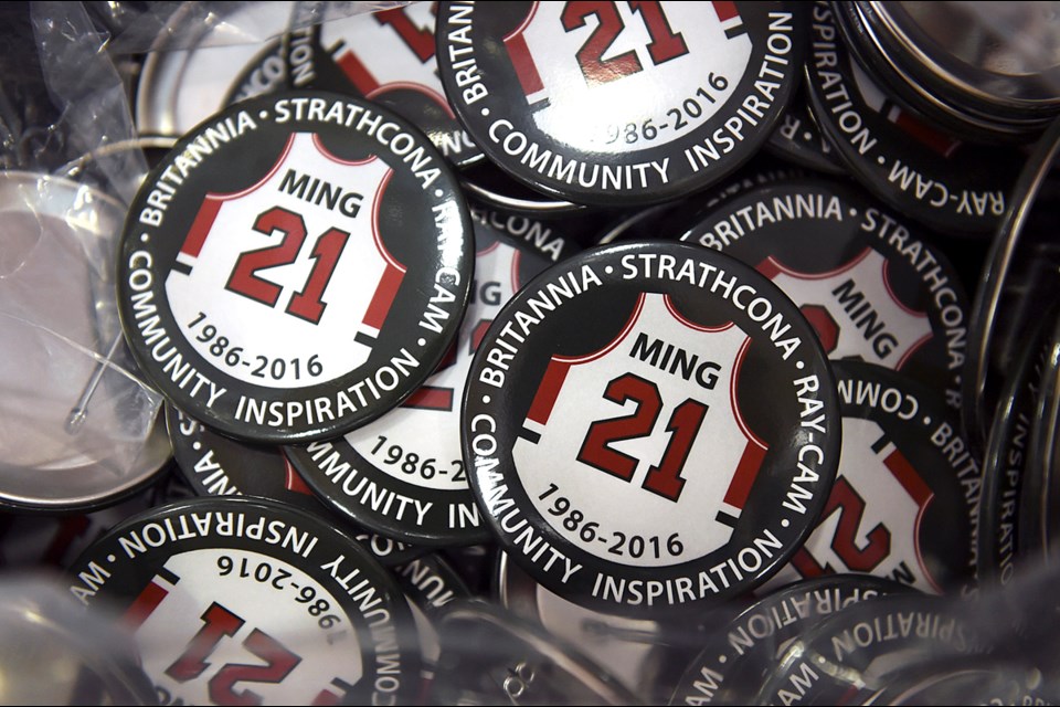 Mitra Tshan designed buttons to commemorate Eric Ming, the coach and community worker who died in September and was posthumously honoured at Britannia secondary Jan. 12, 2017. Photo Dan Toulgoet