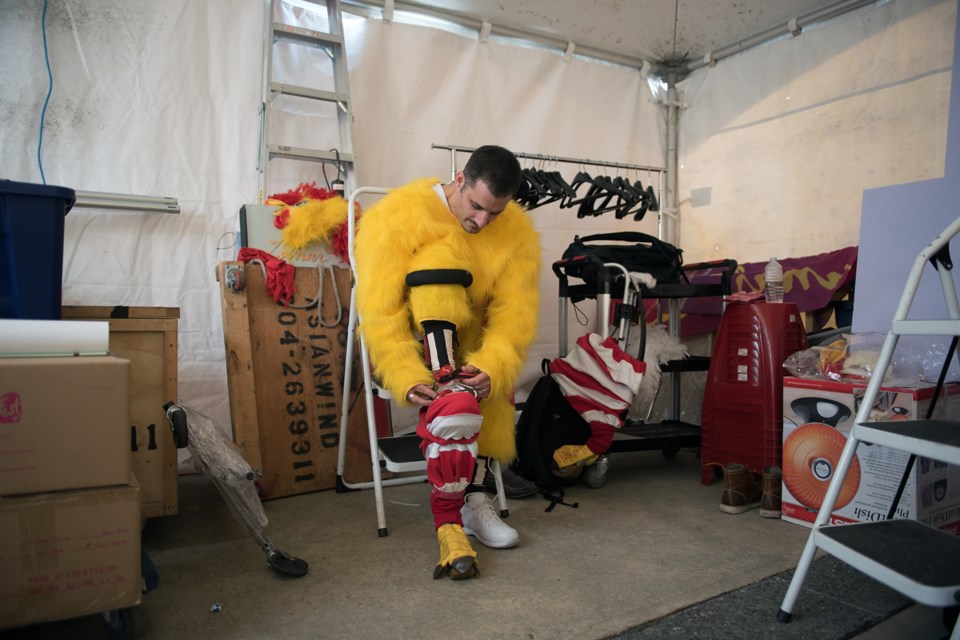 The jumping rooster, otherwise known as Neezar Joseph, entertained during LunarFest at the Queen Elizabeth Plaza Saturday. Photo Rebecca Blissett