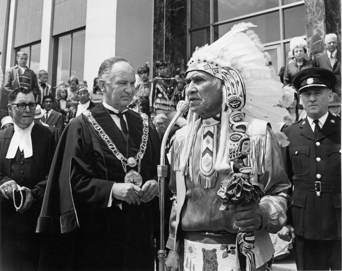 Chief Dan George met with New Westminster Mayor James Stuart Gifford on the steps of the New Westminster City Hall in 1967, part of a ceremony that took place in honour of Canada’s Centennial. As part of the second annual "Indian Days" event, the mayor welcomed tribal chiefs from around the Pacific Northwest to New Westminster, where they took part in events like war canoe races.