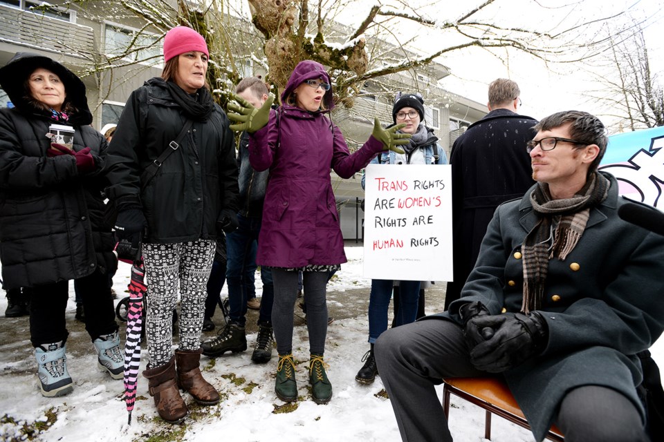 About 30 protesters gathered near New West Community Church in Sapperton Sunday to oppose a campaign against Bill C-16 by pastor Paul Dirks (seated). The proposed legislation would add gender expression and gender identity to the list of prohibited grounds for discrimination in Canada.