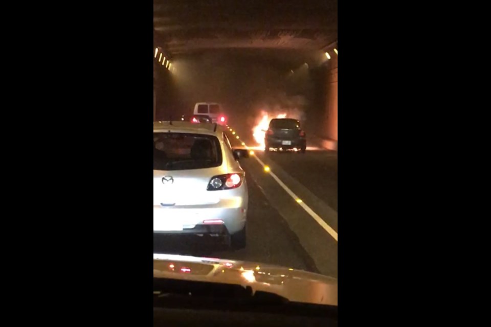 A car caught fire in the Massey Tunnel on Thursday morning, closing traffic in both directions. Twitter photos by Andrew Blacklock