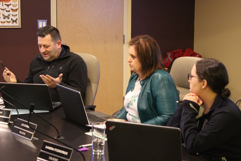 Trustee Ryan Land (left) was the only member of the school board to vote in favour of a resolution t