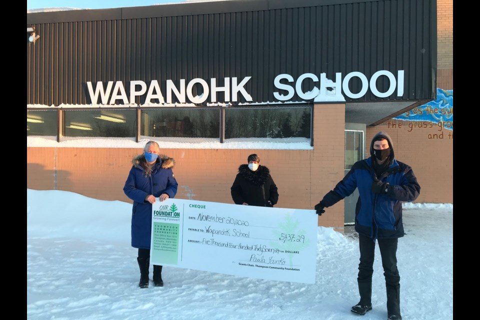 Wapanhk Community School principal Kathleen Kelson, left, accepts a donation from Dave Moore of the Thompson Community Foundation. The money was used to buy dividers to provide one-on-one learning spaces in math and reading.