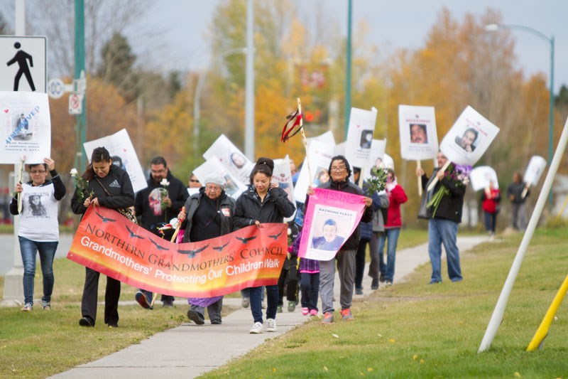 An Oct. 4 march in honour of missing and murdered indigenous people was headed up by a banner highlighting the Northern Grandmothers’ Council, represented by Isabelle Morris (front, centre of sign).