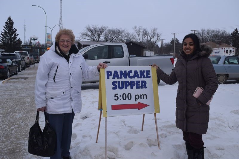 Going into the Masonic Hall in Kamsack on February 28 to enjoy a Shrove Tuesday serving of pancakes and sausages were Isabel Ritchie, left, and Nidhi Nidhi.