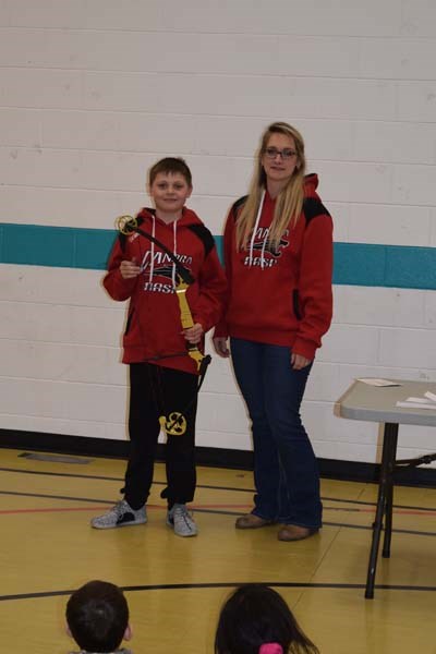 Matthew Makowsky received his golden bow replica for his gold medal performance at nationals from Jennifer Prychak, CJES teacher and NASP coach.