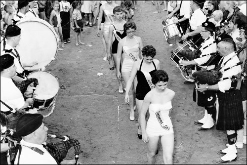 HBM&S Pipe Band parading in the Phantom Lake Beauty Queen contestants on Canada Day, 1957.