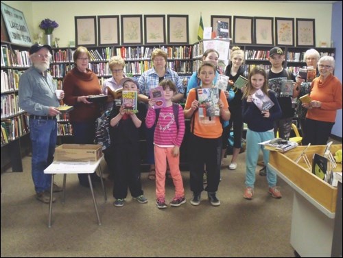 Readers inside Borden Lakeland Library protesting the government cuts to libraries.