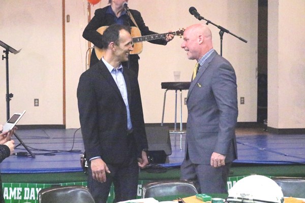 Dan Farthing (left) and Paul LaPolice (right) share a laugh before the 11th annual Football Night in Saskatchewan started.