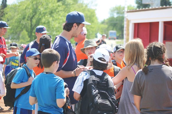 Cardinals head coach Bryn Biancalana is swarmed by excited students looking for autographs after the game.