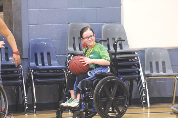 Tiffany McLennan enjoys playing wheelchair basketball with her classmates, as they see gym class from her perspective for the first time.