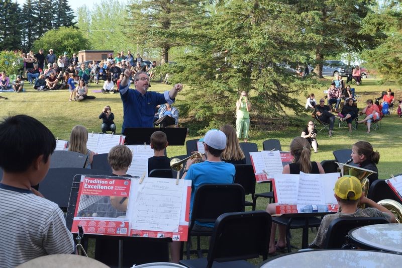 Ideal weather on a sloping lawn relatively free of insect pests helped create an enjoyable outdoor concert on June 12 for the 33rd annual KCI bands’ pie-and-ice cream lawn concert. The beginning, junior and senior bands, under direction of Darren Kitsch performed, while several senior art students displayed their works. See more photos and read the story on pages X and Y.