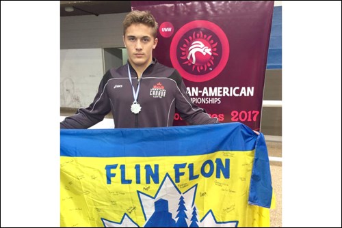 Carson Lee with his United World Wrestling Pan-American silver medal and a Flin Flon flag in Buenos