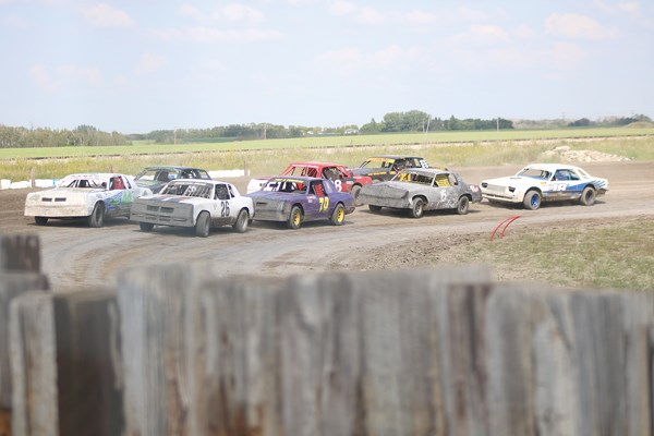 A group of street stock cars get in line before the green flag waves and their race begins.