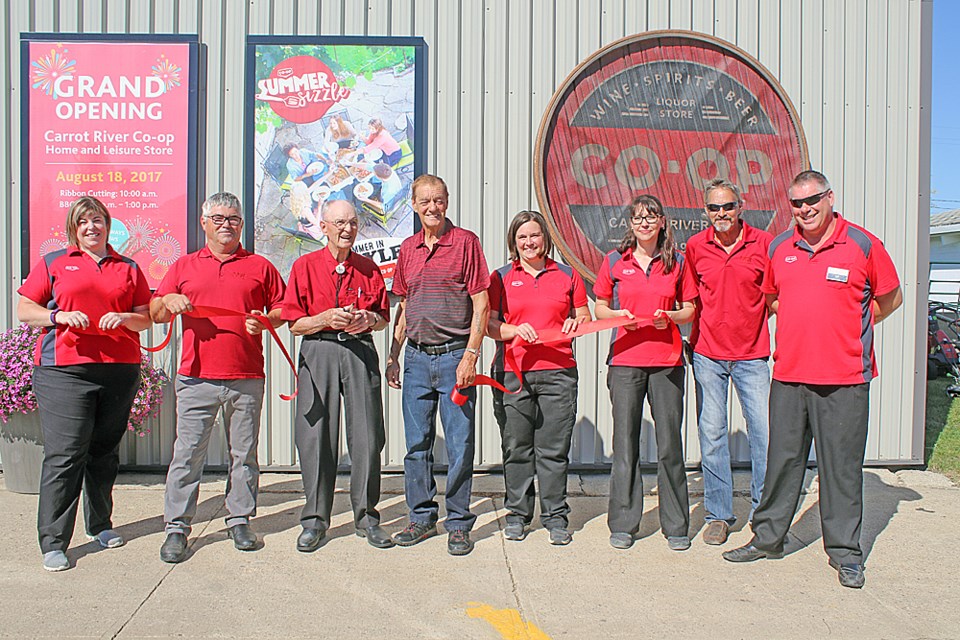 The Carrot River Co-op held a grand opening to celebrate liquor sales in their 1013 Main location Aug. 18. From left are Bev Kott, the liquor commodity manager; Ed Little, the president of the Carrot River Co-op; Bill Crawford, long-time co-op member; Jerry Merrett, the co-op's vice-president; Holly Wiens; Shawn Evans; Todd Kimball, board member; and Ward Kewley, the co-op's general manager. Review Photo/Devan C. Tasa