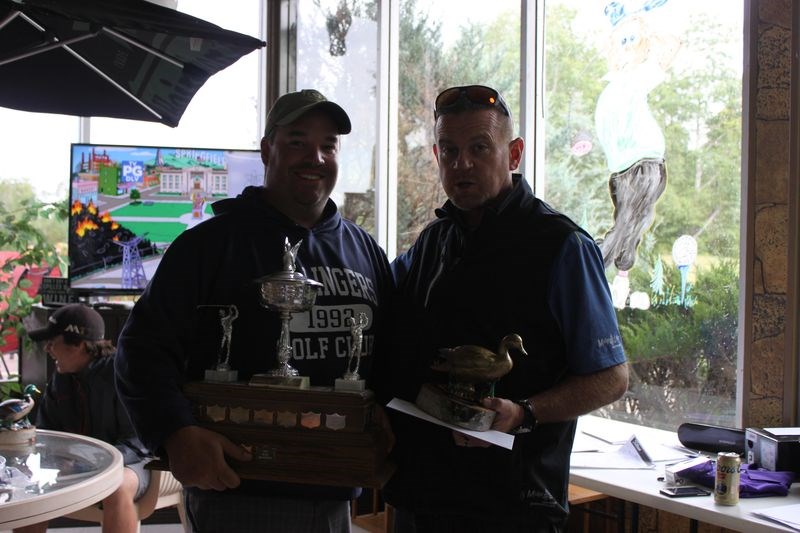 Former Kamsack resident Paul Keys, left, of Yorkton was named the winner of the annual Golden Duck tournament held August 18 to 20. Presenting Keys with his trophy is Rich Patterson, owner of the Madge Lake Golf Resort.