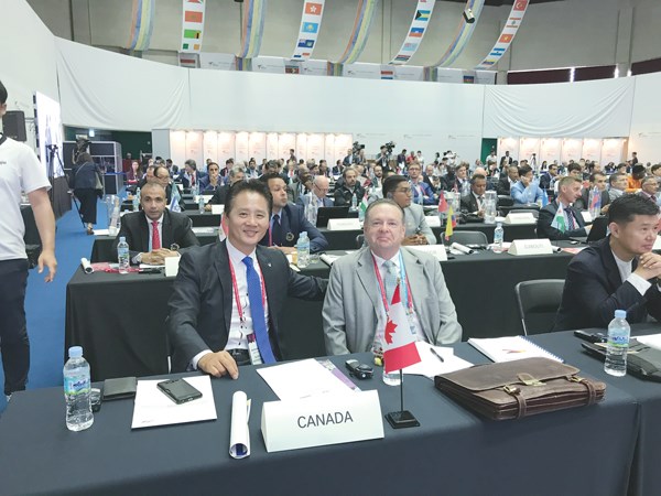 Inseon Kim (left) and Mitchell (right) at the World Taekwondo General Assembley. Mitchell was the voting delegate for Canada and Kim was the non-voting delegate.