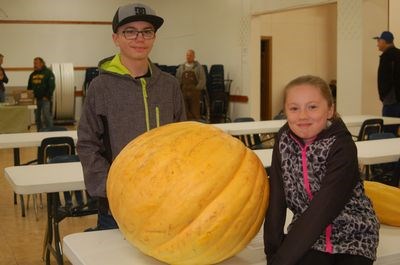 Cayden Worobetz, left, and his sister Jordyn brought in the heaviest pumpkin that topped the scales at 100 pounds.