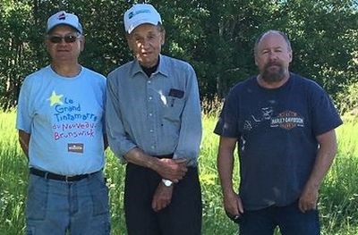 Helping to build the foundation for the commemorative cairn, from left, were: Ken Lozinsky, Adrian Lozinsky and Garnet Mason.