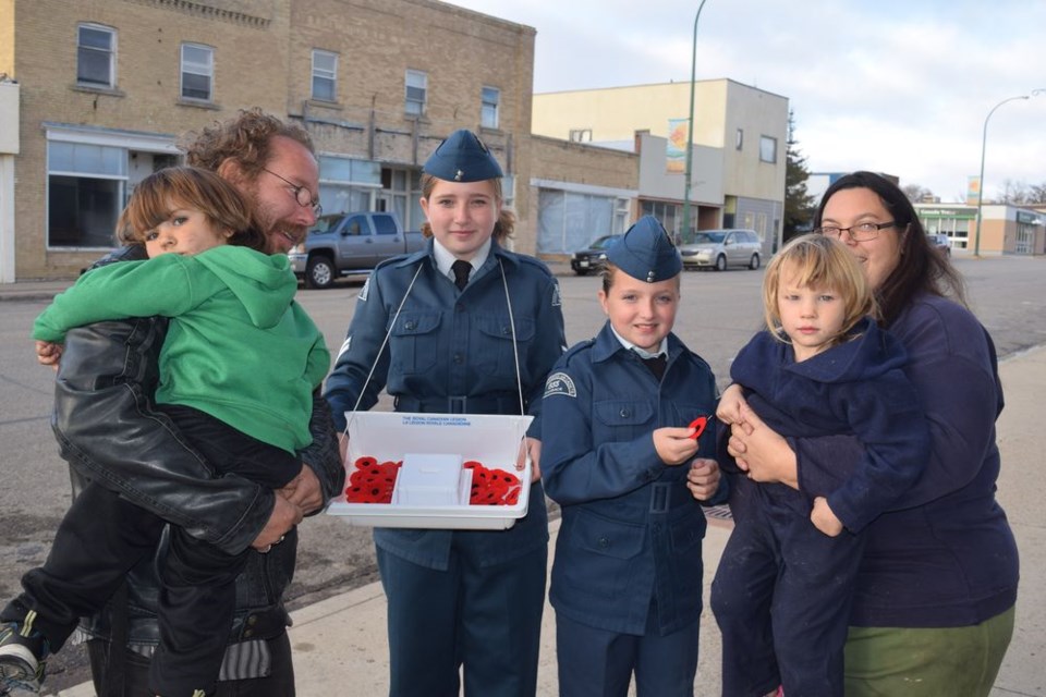 Helping to publicize Poppy Day on Saturday, when Kamsack air cadets will be canvassing the community, selling poppies for the Royal Canadian Legion, from left, were: Paul Loren, holding his son John, Ft. Cpl. Megan Raffard, AC Teanna Raffard and Rebecca Spence holding her daughter Shawntelle.