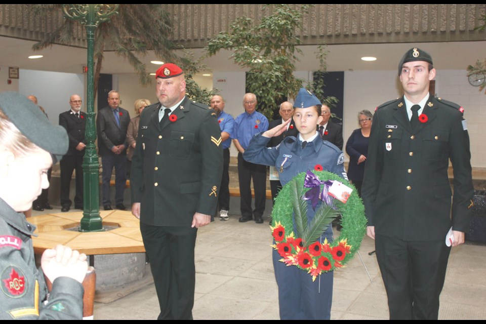 Geoff Thiessen, left, and John Klassen, right, were joined by Sgt. Janna Cinnamon from the No. 30 Wylie-Mitchell Air Cadets to lay a wreath at the cenotaph.