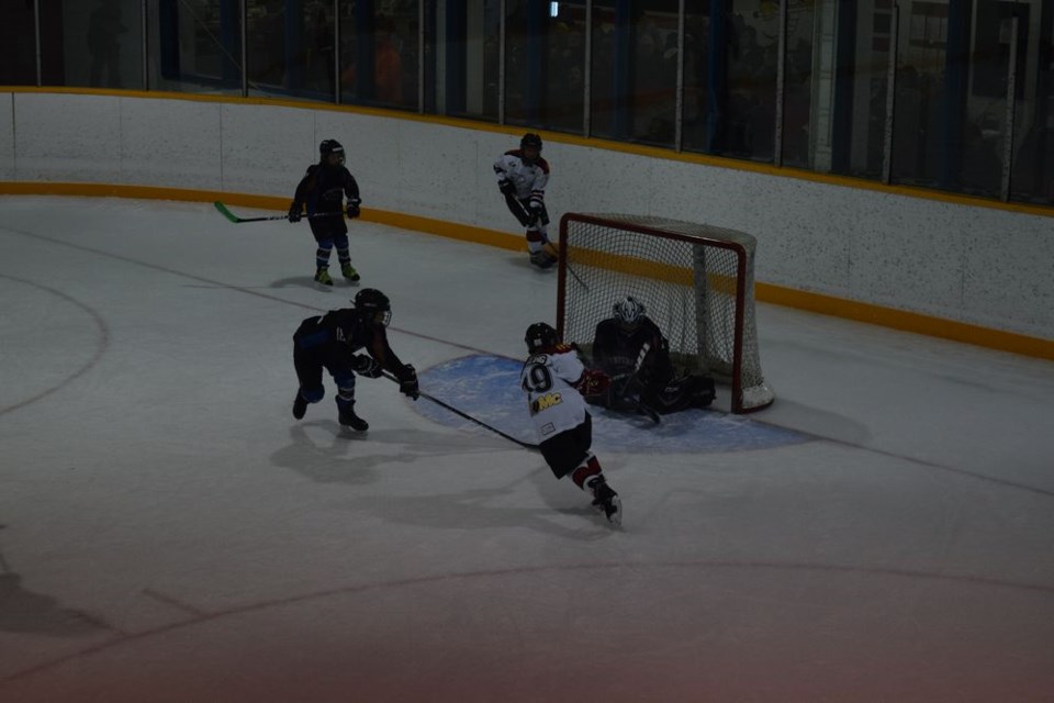 Chase Hembling, Canora Atom White No. 19, shot the puck past the Swan Valley Stampeders goalie and into the net during Canora’s 6-5 shootout loss to the Stampeders on November 26 at the Canora Atom White hockey tournament.