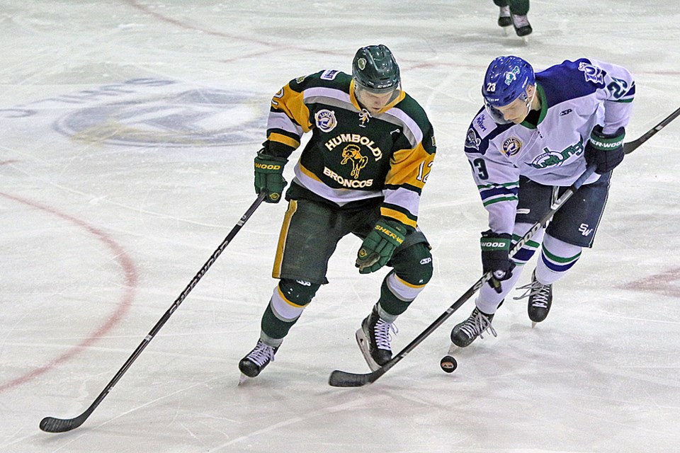 Boedy Donald of the Mustangs battles for control of the puck during the home game against Humboldt Dec. 22. Review Photo/Devan C. Tasa