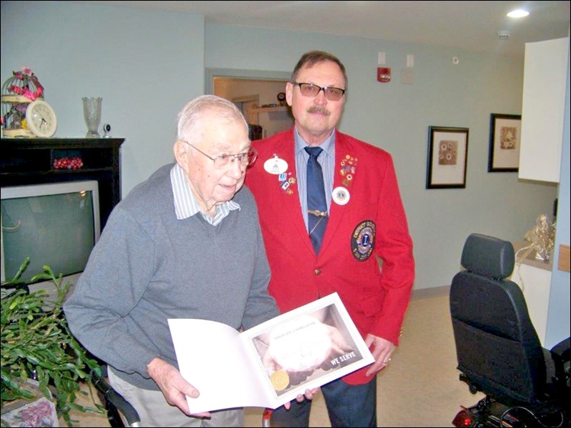 District Governor Dan Babyak presenting special recognition certificate to Lion Murray Taylor at the Borden Care Home on Jan. 20. Photos by Lorraine Olinyk