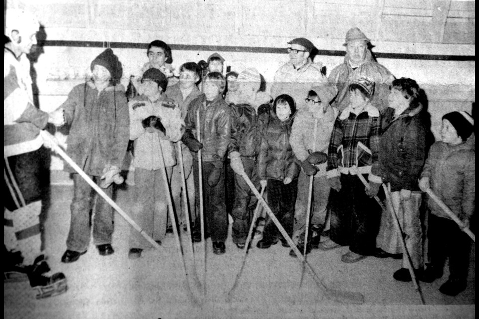 Captain Charlie Fritshaw of the Tisdale Ramblers congratulates the youngsters winning hockey sticks given away last Friday evening as part of the observance of Tisdale Minor Hockey Week. Looking on are [left to right] President Don York of Tisdale Minor Hockey Association; Jim Billy, chairman of minor hockey week program; and President Charlie Bansley of Tisdale Ramblers Hockey Club. The youngsters given the sticks donated by the Ramblers were Dwight Marleau, Mickey York, Wade Fritshaw, Scott McLarty, Bradley Hughes, Dicky Gray, Kevin Stoker, Ian Bromm, Stu Murray, Sheldon Dahl, Ken Koehl and Gilbert Thompson.