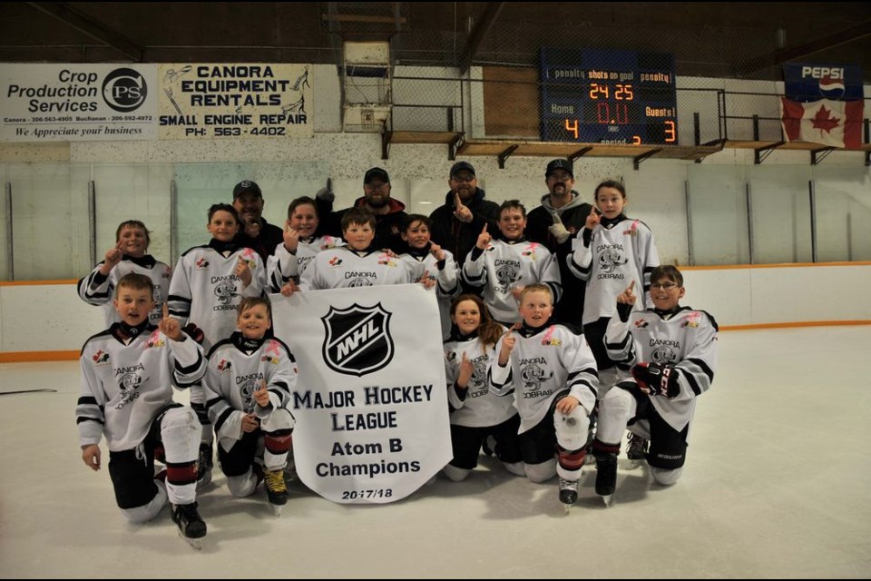 The members of the victorious Canora Atom Black Cobras, from left, were: (back row) Shawn Sleeva, Jeff Sznerch, Trent Wolkowski and Ryan Hauber (coaches); (Middle) Kayden Harder, Cooper Kraynick, Briel Beblow, Cody Vangen, Wyatt Wolkowski, Ty Sleeva and Gabrielle Marcischuk Butler: and (front) Devon Paley, Rhett Ludba, Katherine Hauber, Logan Sznerch, and Tucker Mydonick