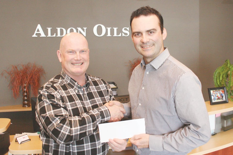 Del Mondor from the Saskatchewan Oil & Gas Show, left, presented a $5,000 donation to Dave Harazny with Southeast College. Photo submitted